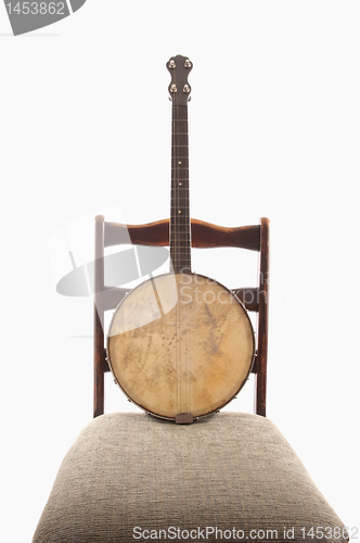 Image of Antique Banjo On Antique Chair