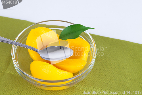 Image of Peaches in sweet syrup.