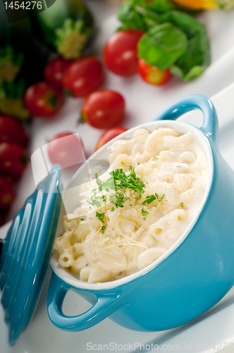 Image of mac and cheese on a blue little clay pot