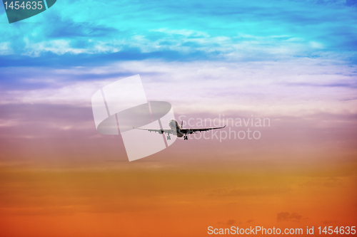 Image of Passenger plane takes off at sunset