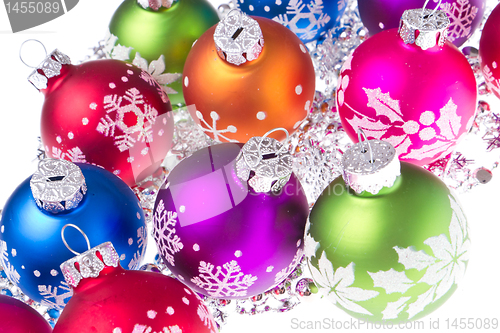 Image of christmas balls with snowflake symbols