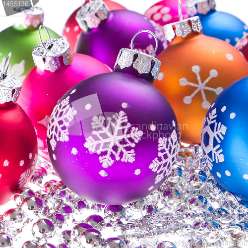 Image of christmas balls with snowflake symbols