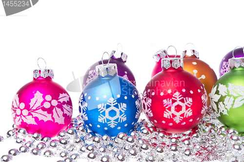 Image of christmas balls with snowflake symbols