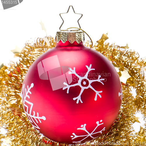 Image of christmas ball with snowflake symbols and tinsel