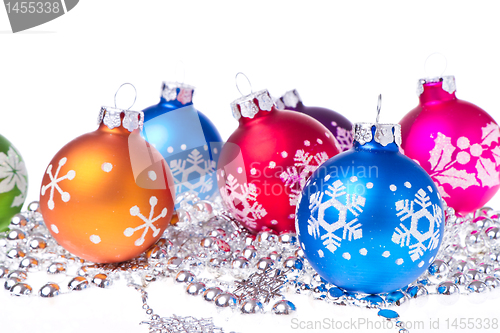 Image of christmas balls with snowflake symbols