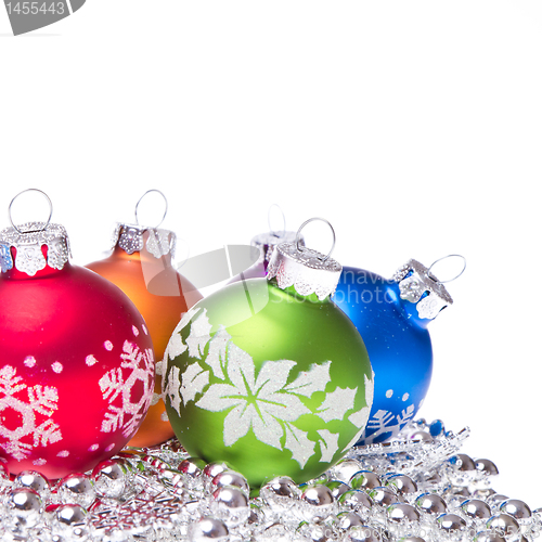 Image of christmas balls with snowflake symbols