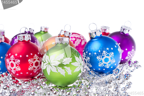 Image of christmas balls with snowflake symbols