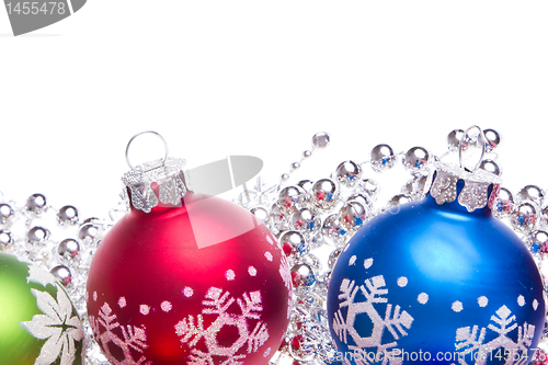 Image of christmas balls with snowflake symbols