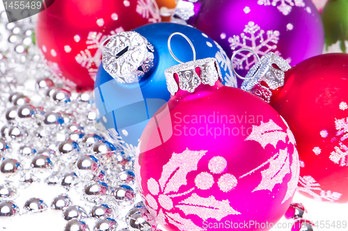 Image of christmas balls with snowflake symbols
