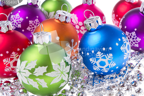 Image of christmas balls with snowflake symbols