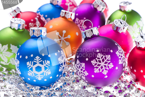 Image of christmas balls with snowflake symbols