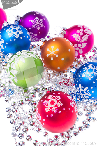 Image of christmas balls with snowflake symbols