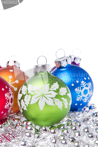 Image of christmas balls with snowflake symbols