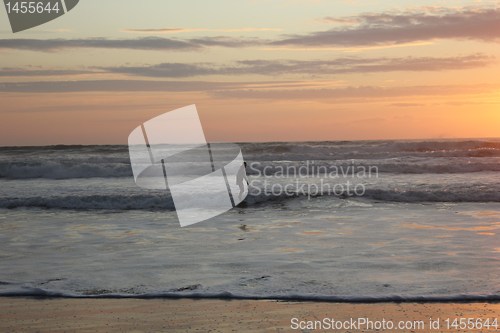 Image of surfing at sunset