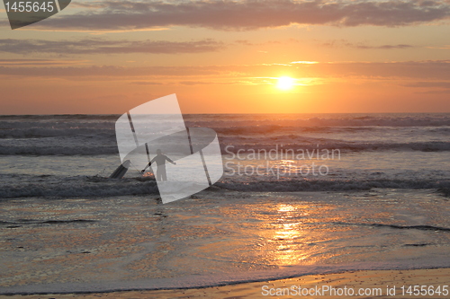 Image of surfing at sunset