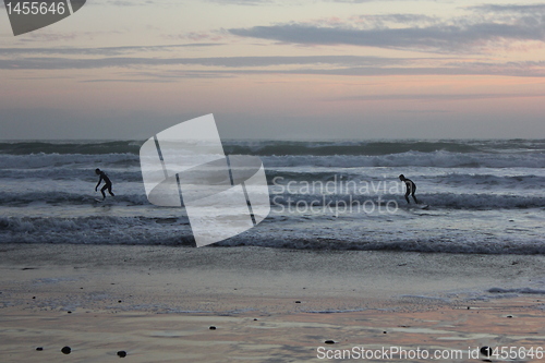 Image of surfing at sunset
