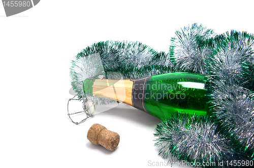 Image of Empty bottle of champagne and Christmas tinsel 