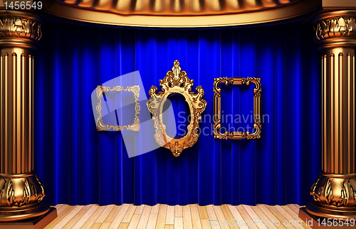 Image of blue curtains, gold columns and frames