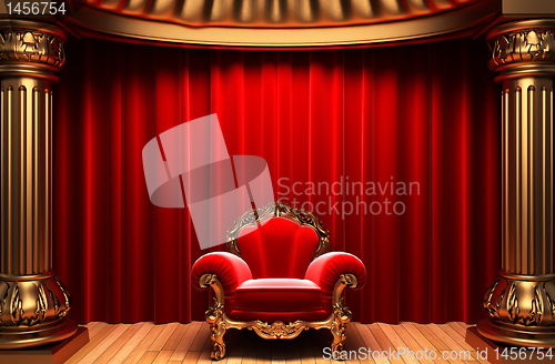Image of red velvet curtains, gold columns and chair