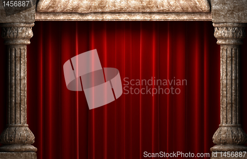 Image of red velvet curtains behind the stone columns