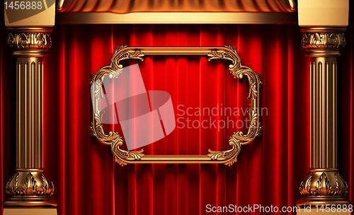 Image of red curtains, gold columns and frames