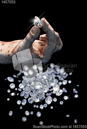 Image of Diamonds on black surface and hand