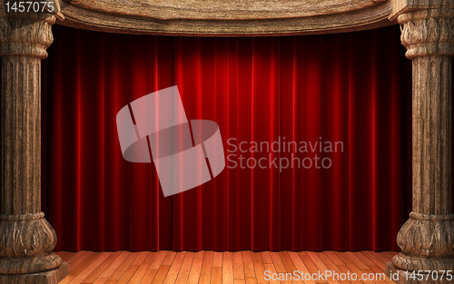 Image of red velvet curtains behind the old wood columns