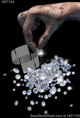 Image of Diamonds on black surface and hand
