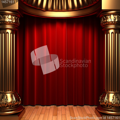 Image of red velvet curtains behind the gold columns