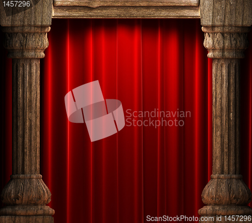 Image of red velvet curtains behind the old wood columns