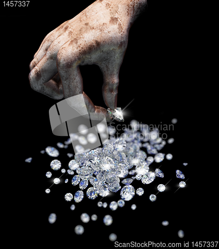 Image of Diamonds on black surface and hand