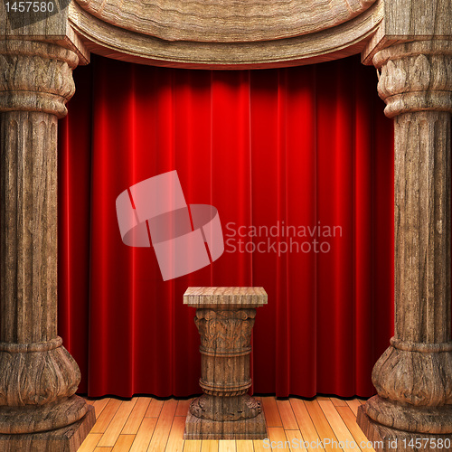 Image of red velvet curtains, wood columns and Pedestal