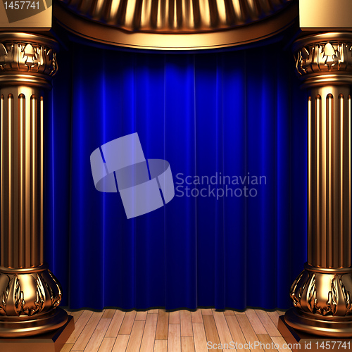 Image of blue velvet curtains behind the gold columns