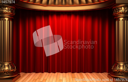 Image of red velvet curtains behind the gold columns