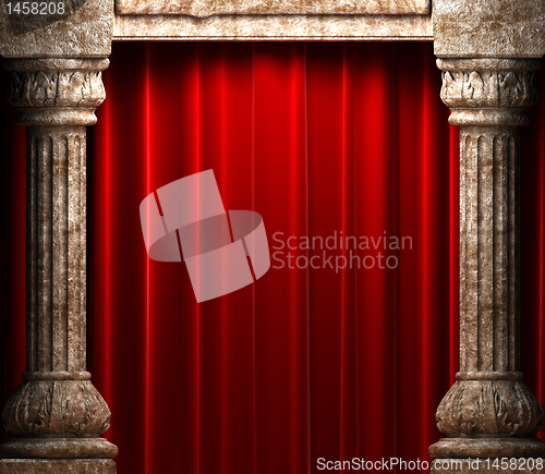 Image of red velvet curtains behind the stone columns