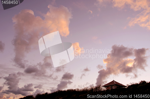 Image of Small wooden house at seaside on background of sky