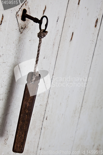 Image of Old key in old door