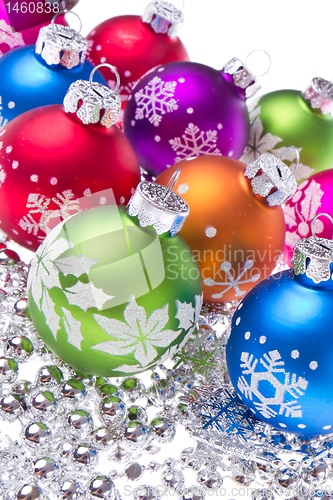 Image of christmas balls with snowflake symbols