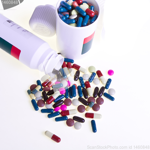 Image of pills spilling out of container 