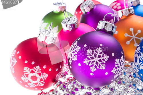 Image of christmas balls with snowflake symbols