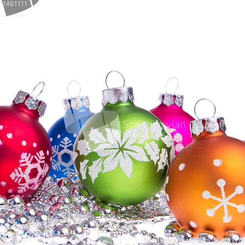 Image of christmas balls with snowflake symbols