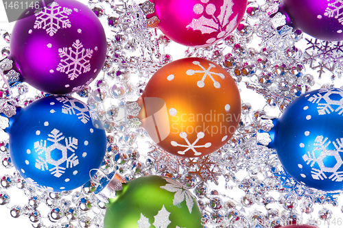 Image of christmas balls with snowflake symbols