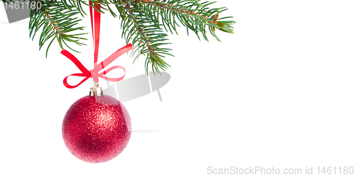 Image of red christmas ball hanging from tree