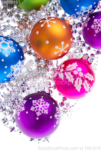 Image of christmas balls with snowflake symbols