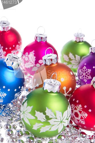 Image of christmas balls with snowflake symbols