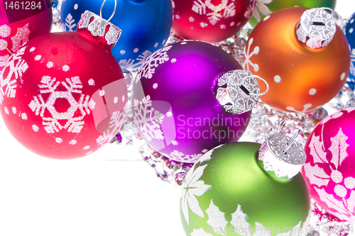 Image of christmas balls with snowflake symbols