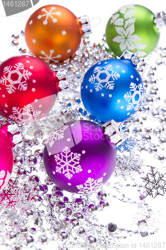 Image of christmas balls with snowflake symbols