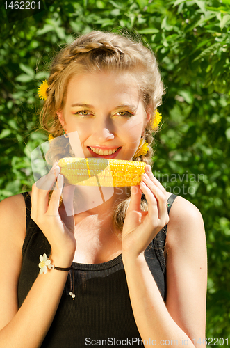 Image of woman eating corn-cob