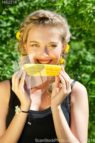 Image of woman eating corn-cob