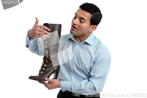 Image of Shoe salesman showing women's boot